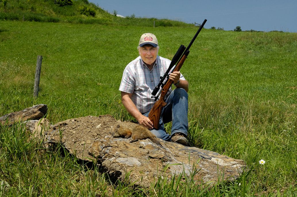 It was a long walk from the crest of the hill in the background, but this chuck was easy prey for the 6mm Remington. Stan took the shot from resting the gun on the boulder he is sitting on.